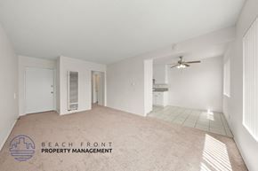 Inglewood apartment for rent - A spacious room with a ceiling fan and a logo for Beach Front Property Management.