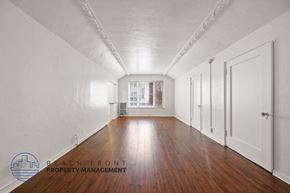 Los Angeles apartment for rent - A long hallway with wooden floors and white walls.