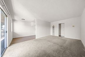 Inglewood apartment for rent - A spacious room with a carpeted floor and white walls.