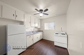 Wilmington apartment for rent - A kitchen with white appliances and wooden floors.