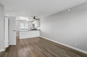 Hawthorne apartment for rent - A room with a ceiling fan and wooden flooring.