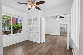 Long Beach apartment for rent - A spacious room with a ceiling fan and wooden flooring.
