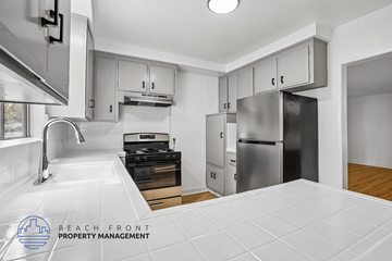 San Pedro apartment for rent - A kitchen with a stove top oven and a refrigerator.