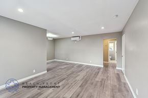 Los Angeles apartment for rent - A spacious room with wooden flooring and a doorway leading to another room.