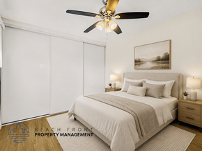 Downey apartment for rent - A bedroom with a bed, a ceiling fan, and a painting on the wall.