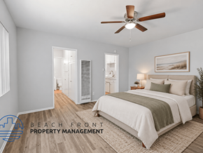 Long Beach apartment for rent - A bedroom with a bed, a ceiling fan, and a painting on the wall.