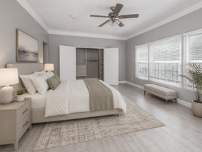 Los Angeles apartment for rent - A bedroom with a large bed, a ceiling fan, and a window with blinds.