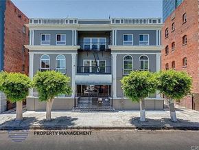 Los Angeles apartment for rent - a blue building with three trees in front of it