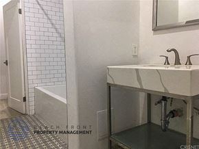 Los Angeles apartment for rent - a bathroom with a sink and a tub and a mirror