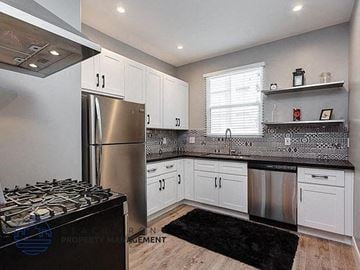 Los Angeles apartment for rent - a kitchen with white cabinets and a stainless steel refrigerator