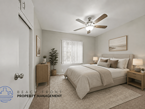 Downey apartment for rent - A bedroom with a bed, nightstand, and a plant.