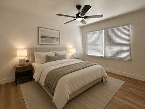 Santa Ana apartment for rent - A bedroom with a large bed, a ceiling fan, and a window with blinds.
