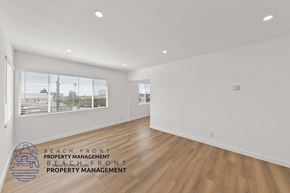 Santa Monica apartment for rent - the living room of an apartment with white walls and wood floors