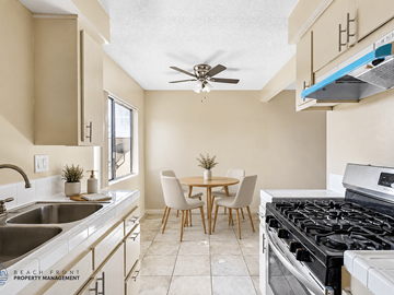Hawthorne apartment for rent - A kitchen with a stove, sink, and dining table.