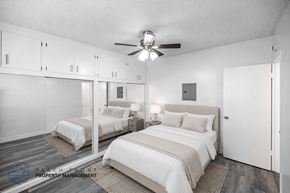 Long Beach apartment for rent - A bedroom with two beds and a ceiling fan.