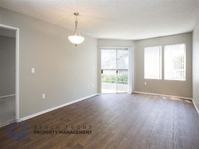 San Pedro apartment for rent - A room with wooden floors and a sliding glass door leading to a balcony.