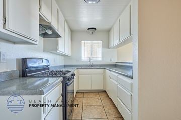 Long Beach apartment for rent - A kitchen with a stove top oven and a sink.