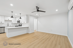 Long Beach apartment for rent - A spacious kitchen with a white island and a ceiling fan.