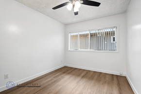 Gardena apartment for rent - A room with a ceiling fan and a window with blinds.