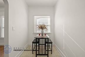 Los Angeles apartment for rent - A dining table with two chairs is in a white room with a window.
