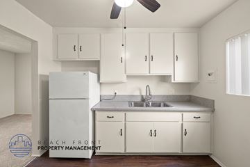 Wilmington apartment for rent - A kitchen with white cabinets and a refrigerator.