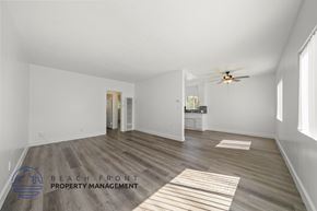 Inglewood apartment for rent - A spacious room with wooden flooring and a ceiling fan.