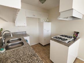 San Pedro apartment for rent - A kitchen with a granite countertop and stainless steel sink.