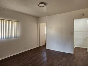 Signal Hill apartment for rent - the living room of an apartment with wood flooring and a door to a closet
