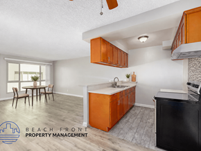 Los Angeles apartment for rent - A kitchen with orange cabinets and a black fridge is shown.