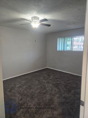 Norwalk apartment for rent - A room with a ceiling fan and carpeted floor.