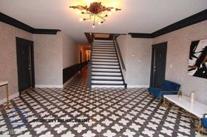 Los Angeles apartment for rent - the lobby of a building with a staircase and a checkered floor
