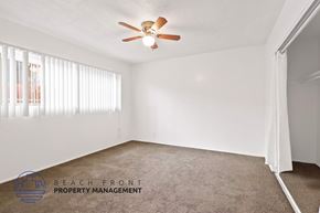 Long Beach apartment for rent - A room with a ceiling fan and carpeted floor.