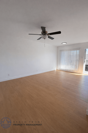 Long Beach apartment for rent - A room with a ceiling fan and wooden flooring.