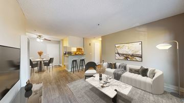 Paramount apartment for rent - A living room with a white couch and a grey rug.