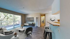 Paramount apartment for rent - A modern living room with a large window and a flat screen TV.