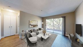 Paramount apartment for rent - A living room with a grey couch and a painting on the wall.