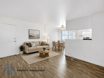 Harbor City apartment for rent - A living room with a couch, coffee table, and a painting on the wall.