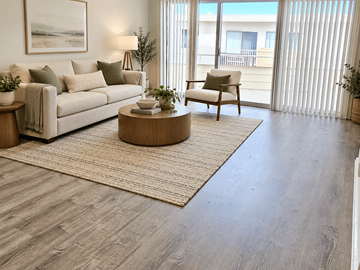 Redondo Beach apartment for rent - A living room with a couch, chair, and a table with a plant on it.