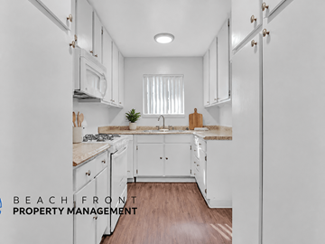 El Monte apartment for rent - A kitchen with white cabinets and a wooden floor.