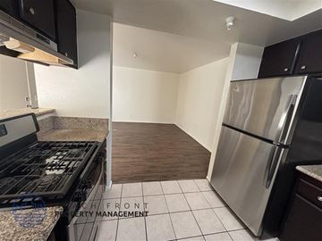 Hawthorne apartment for rent - A kitchen with a stove top oven and a refrigerator.