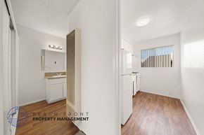 Hawthorne apartment for rent - A kitchen with a refrigerator, sink, and cabinets.