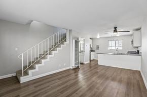 Hawthorne apartment for rent - A spacious room with a staircase and a kitchen area.