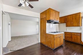Inglewood apartment for rent - A kitchen with wooden cabinets and a ceiling fan.