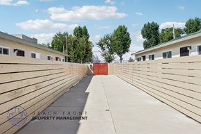 Buena Park apartment for rent - A long concrete walkway with a red door at the end.