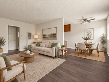 Inglewood apartment for rent - A living room with a white couch, a wooden coffee table, and a painting on the wall.