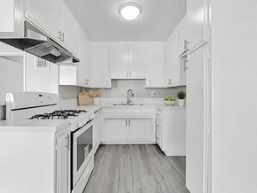 Inglewood apartment for rent - A white kitchen with a stove, sink, and refrigerator.