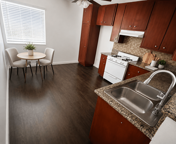 Torrance apartment for rent - A kitchen with a table and chairs in front of a window.