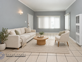 Long Beach apartment for rent - A living room with a white sofa, a wooden coffee table, and a beige rug.