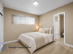 Hawthorne apartment for rent - A bedroom with a bed, pillows, and a lamp.