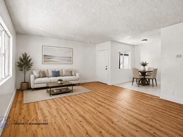 Long Beach apartment for rent - A living room with a white couch, a coffee table, and a painting on the wall.